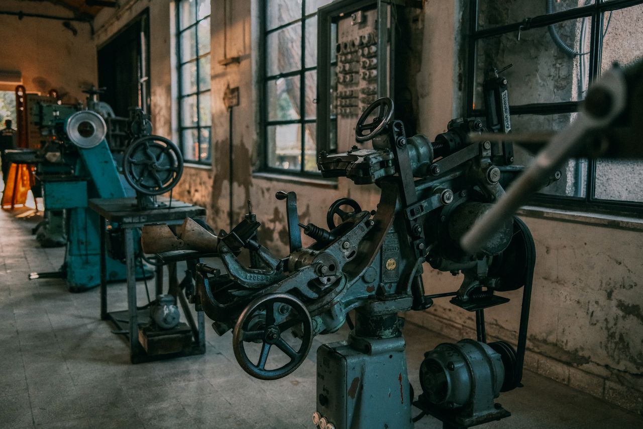 brand-03 Old industrial machines in an abandoned workshop with vintage tools and equipment.