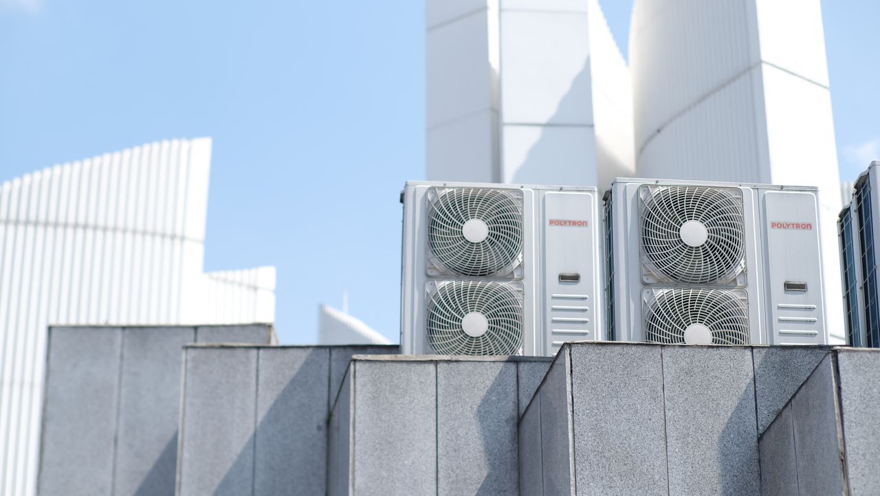 brand-01 Air conditioner units on a city rooftop in Bandung, Indonesia, showcasing modern urban architecture.