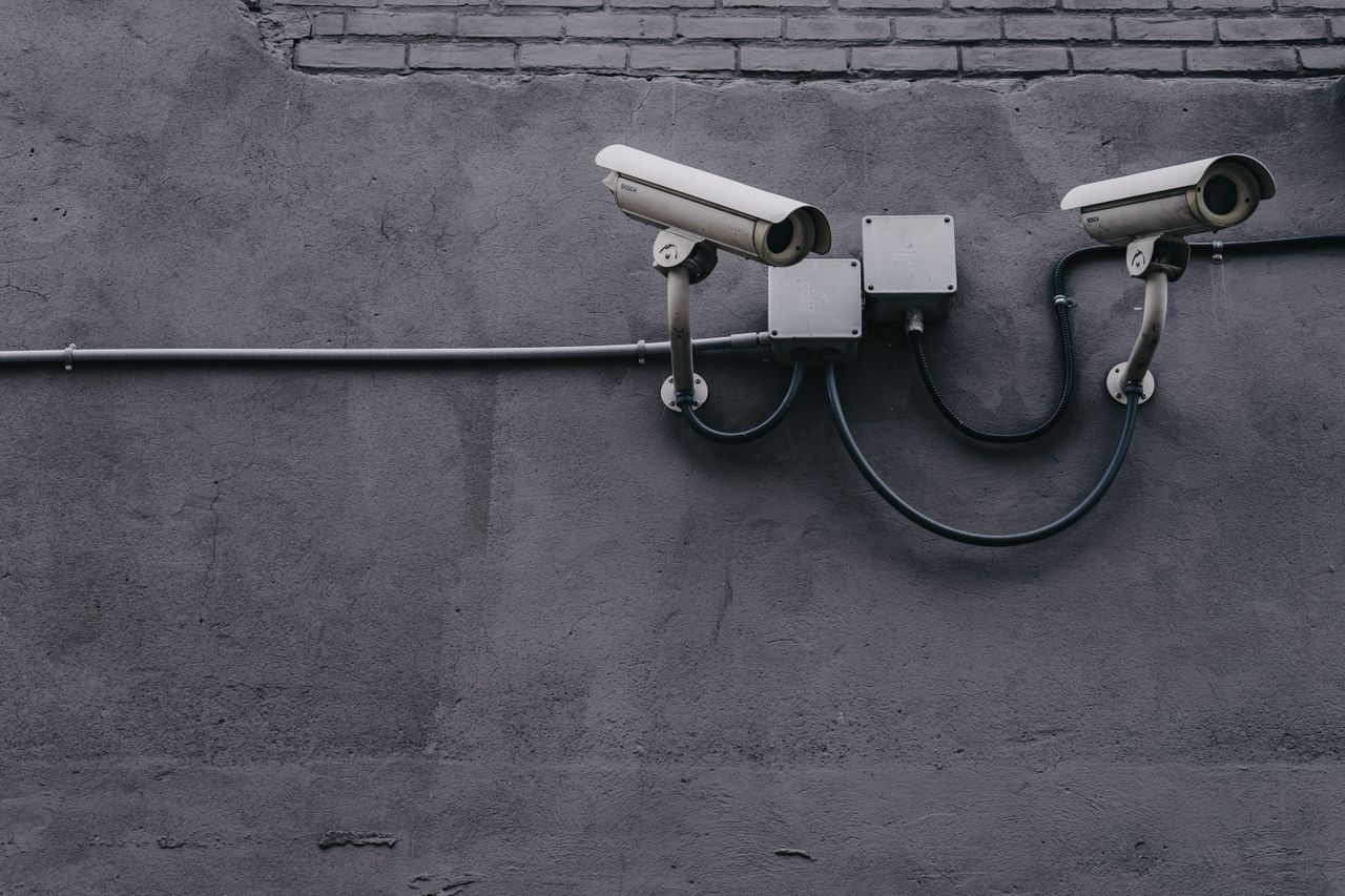 mobile-01 Two surveillance cameras mounted on a concrete wall, highlighting security technology.